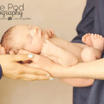 parents-holidng-newborn-baby-in-hands