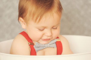 Best-Baby-Photographer-Westwood-Studio-Portrait-Session-First-Birthday-Cake-Smash-Looking-Down-Bowtie