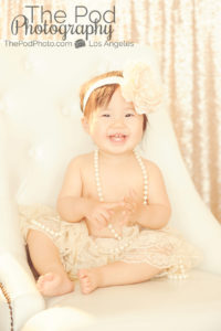 One-Year-Old-Portrait-Photographer-Marina-Del-Rey-Studio-Pod-Glow-Classic-Chair-Tutu-Lace-Headband-Pearls-Sparkle-Sequins