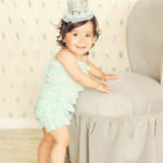 Best-First-Birthday-Cake-Smash-Photographer-Los-Angeles-Portrait-Studio-Teal-Romper-Sequins-Sparkle-Princess-Crown-Silver-Standing-Cute-Girly-Style