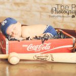 baseball themed newborn photos - baby in coke crate with sports props