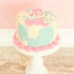 susiecakes first birthday smash cake pink blue and white bubbles