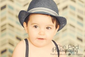 Baby-Boy-Portraits-Los-Angeles-Fedora-Suspenders-Blurry-Background-Close-Up