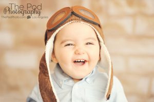 Manhattan-Beach-Los-Angeles-Baby-Boy-Photographer-Full-Service-Studio-Aviator-Hat-Traveler-Set-Brick-Background