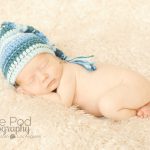 blue elf hat on a sleeping newborn baby boy