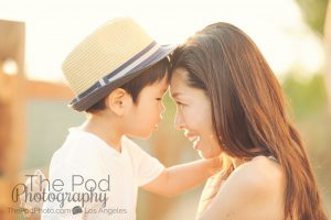 mom and young son touching foreheads