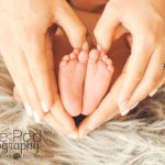 baby-feet-in-heart-shaped-hands
