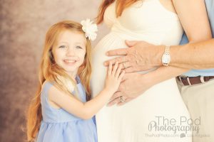 cute-kid-holding-moms-pregnant-belly