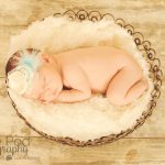 baby in basket with blue headband