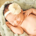 smiling-newborn-baby-with-teal-lace-and-cream-headband-beverly-hills