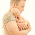 tatooed-dad-holding-newborn-baby
