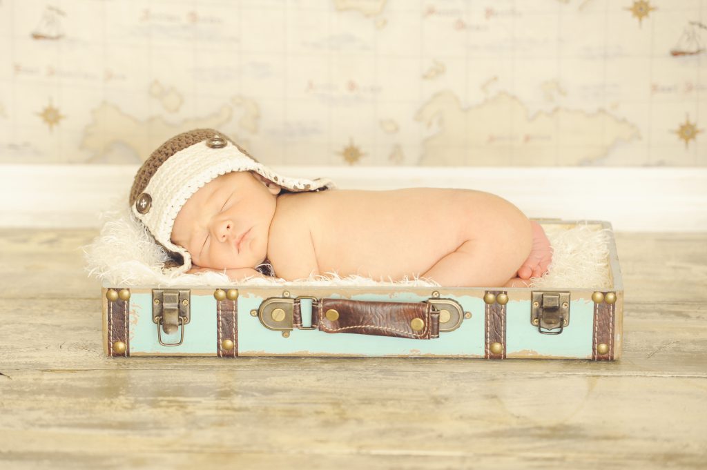 baby-in-suitcase-aviator-hat-travel 