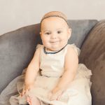 Classic-Six-Month-Baby-Girl-Sitting-Chic-Gray-Couch-Holiday-Portraits-Brentwood
