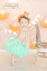 one-year-old-teal-tutu-pink-and-gold-standing-up