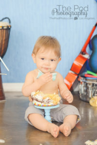 baby-eating-first-birthday-smash-cake-music-theme