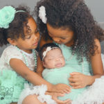 sisters-kissing-new-baby