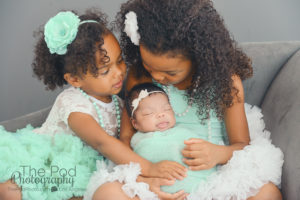 sisters-kissing-new-baby