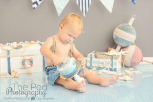 one-year-boy-knocking-cake-over