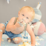 boy-eating-first-birthday-cake