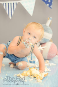 boy-eating-first-birthday-cake