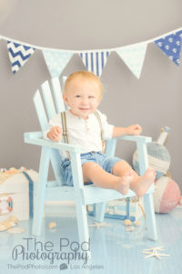 one-year-old-boy-sitting-in-blue-beach-chair