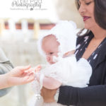 Godparents giving baby baptism necklace gift