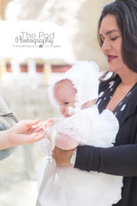 Godparents giving baby baptism necklace gift