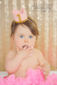 first-birthday-girl-eating-cake