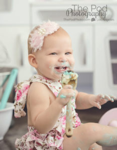 one-year-old-girl-celebrating-birthday-with-cake