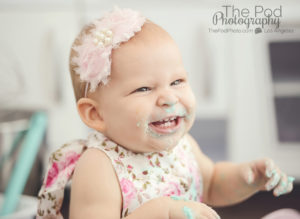 happy-smiling-baby-girl-covered-in-cake