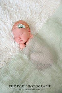 peaceful-newborn-baby-wrapped-in-green-los-angeles