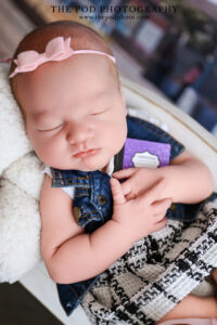 sleeping-newborn-baby-with-miniature-backpack