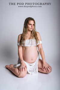 editorial-maternity-photo-kneeling-wet-white-gown-soft-strength