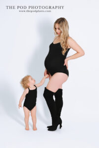 toddler-touching-baby-bump-maternity-photo