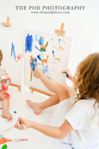 girl-using-foot-to-paint-on-canvas