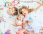 paint-splattered-kids-smiling-on-floor