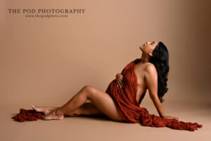 editorial-maternity-reclining-rust-drape-the-pod-photography