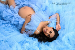 maternity-portrait-blue-tulle-gown-lying-the-pod-photography