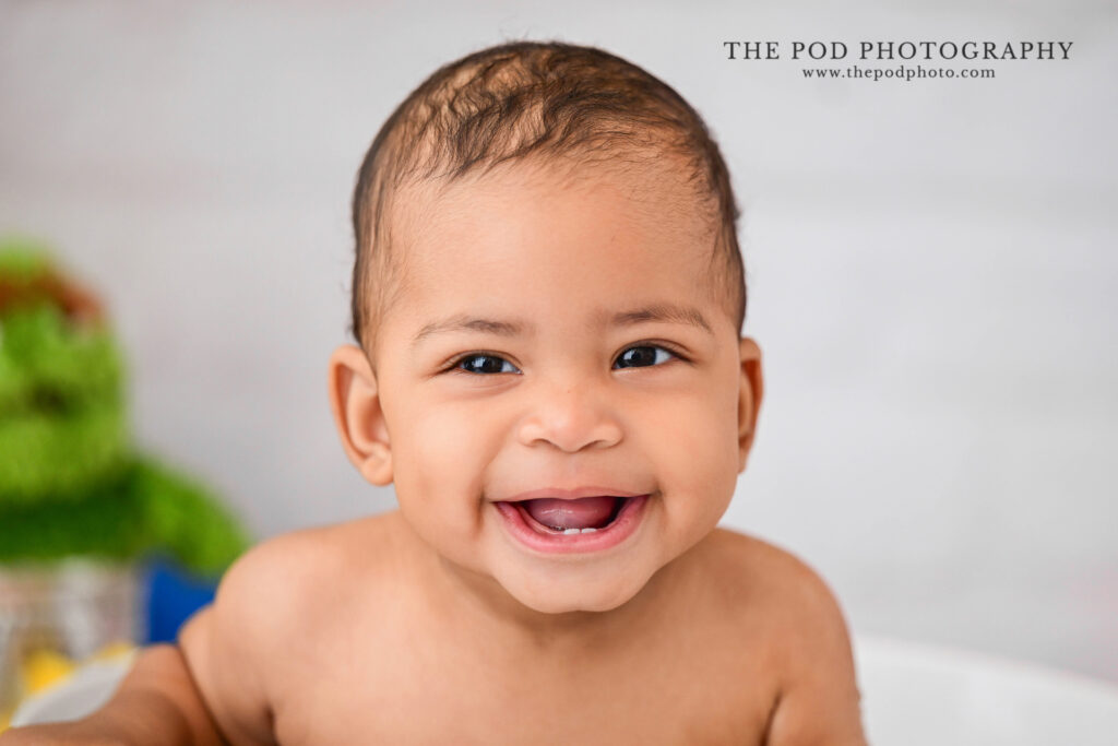 Close-up milestone portrait capturing baby's smile and personality