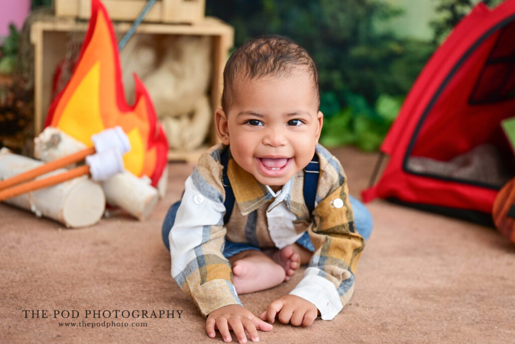 Baby milestone portrait featuring a camping-themed set at The Pod Photography