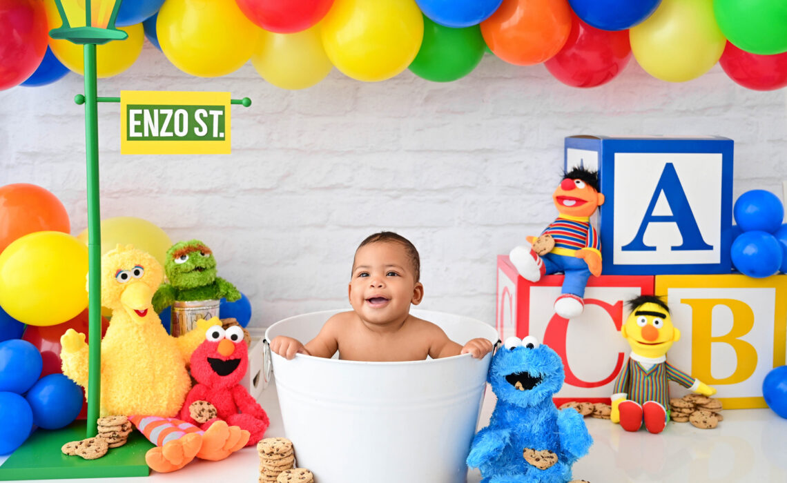 Smiling six month old photographed in a Sesame Street inspired milestone session