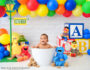 Smiling six month old photographed in a Sesame Street inspired milestone session